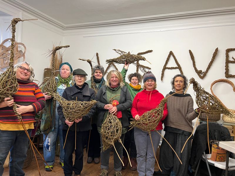 Students with willow bird sculptures