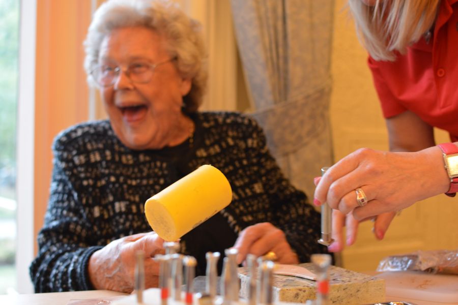 A lady having the time of her life tooling leather