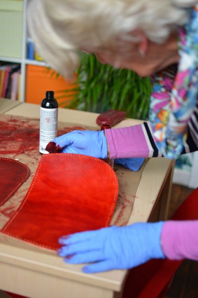 Lady making a leather handbag