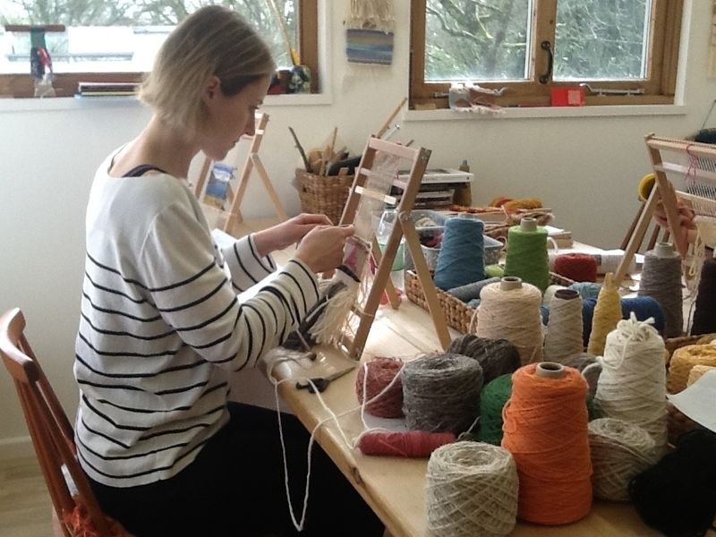 LYL Student weaving on loom