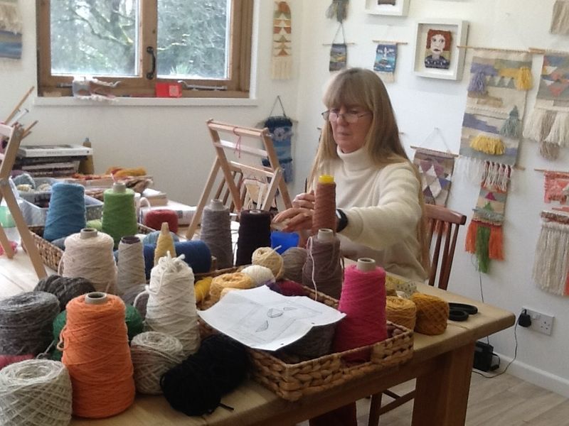 LYL Student weaving on loom