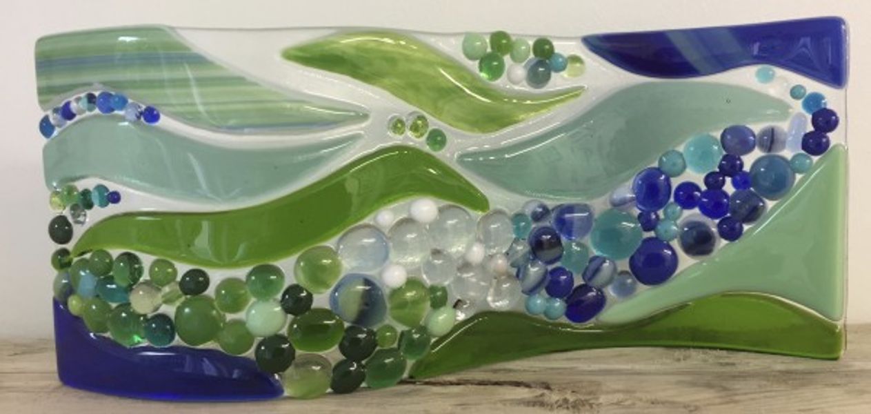 Made on our Full Day Introduction to Glass Fusing a lovely flowing abstract scene by Katie.