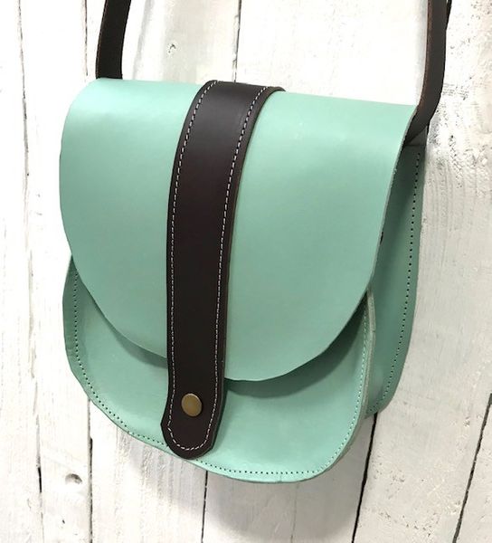 Finished duck egg blue and dark brown leather saddle bag by a student on the course