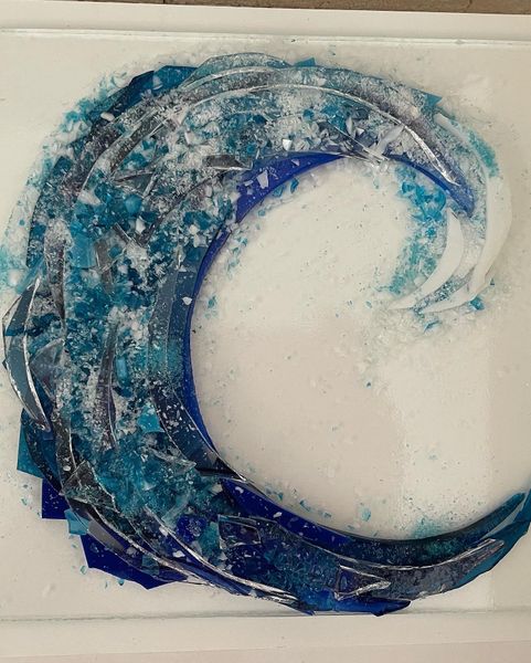 A wave made with coloured frit and clear glass before firing.