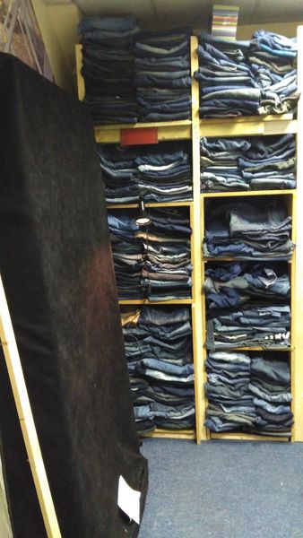Floor to ceiling Denim Jeans some to study pockets cut and fit .