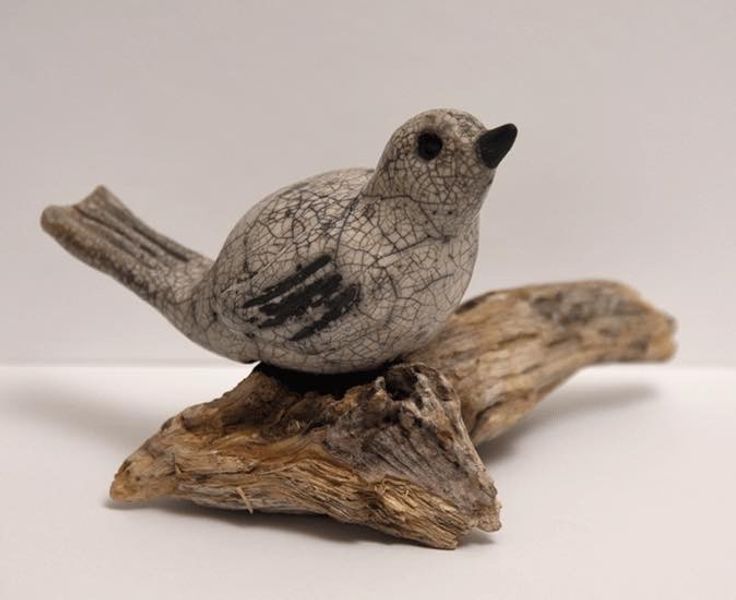 Bird in white crackle on driftwood