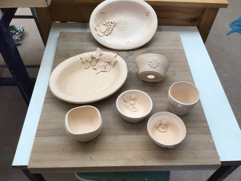 Beginner student pots after bisque firing