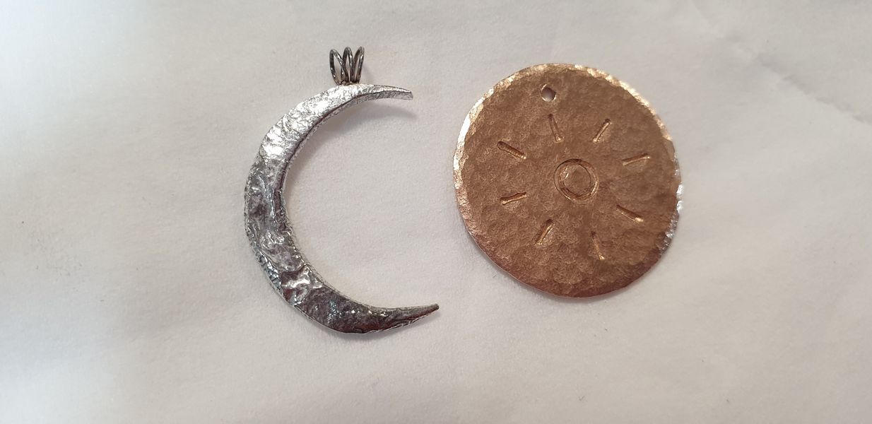 Reticulated silver moon and stamped  bronze, sun pendant, a lovely pair by a lovely couple!