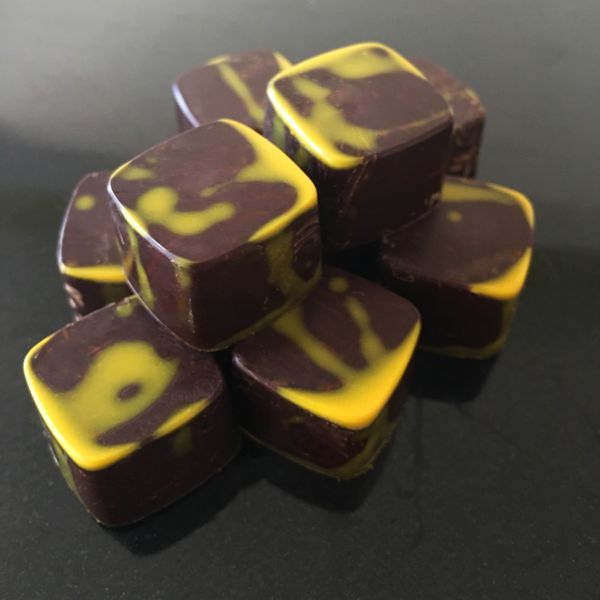 Moulded chocolates with a yellow cocoa butter accent.