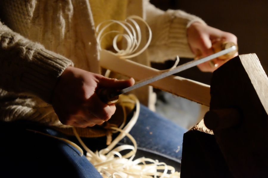 Using traditional hand tools to shave down the rungs