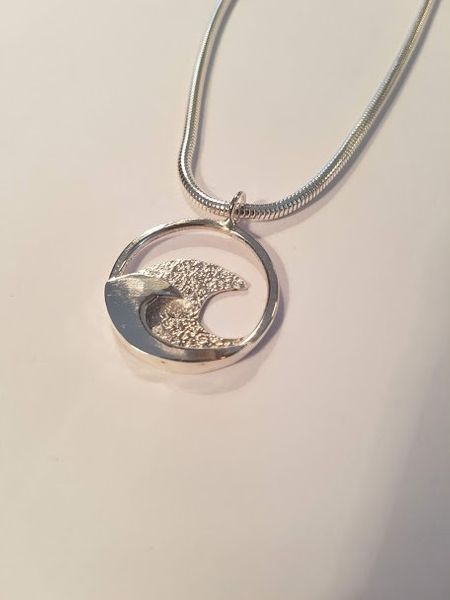 Silver wave pendant made at the all day jewellery workshop Wales