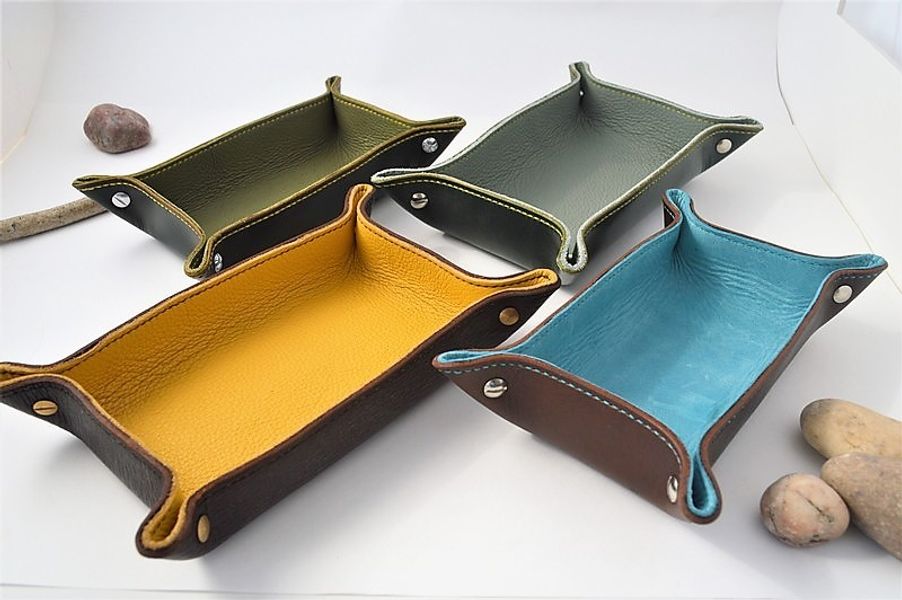 Lined and stitched valet trays with metal fittings.