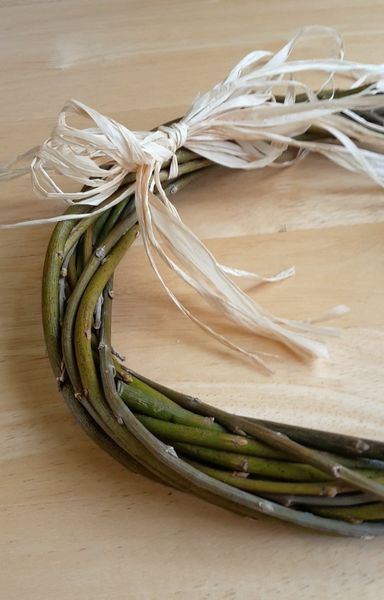 Raffia bow added to rustic willow wreath