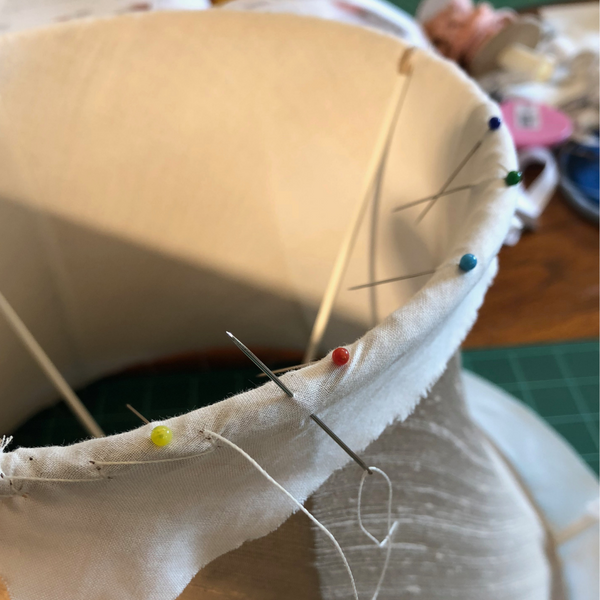 Lampshade stitching lining on a handmade traditional tailored lampshade