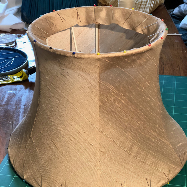 Pinning one of a pair of silk dupion handmade traditional tailored lampshade