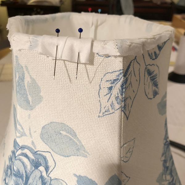 Pinning the gimbal tidy in position on a cute cotton floral tailored lampshade