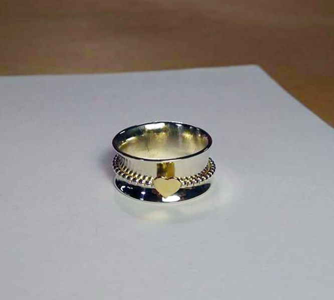 spinner ring with brass heart made by a srudent