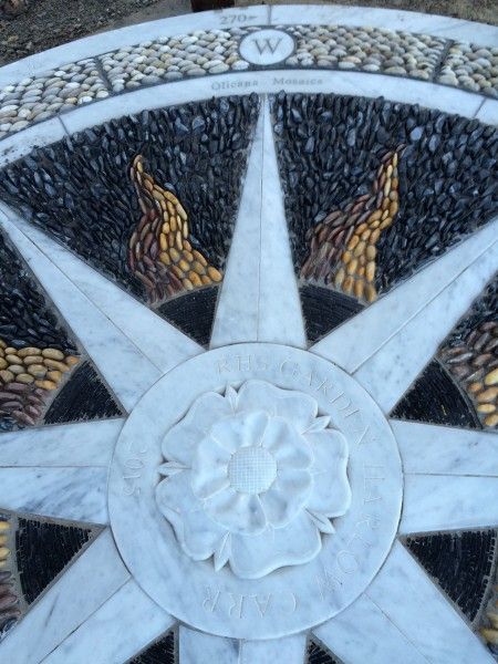 David James of Olicana Mosaics -RHS Garden Harlow Carr explorers compass in pebble sectional mosaic, marble and slate.