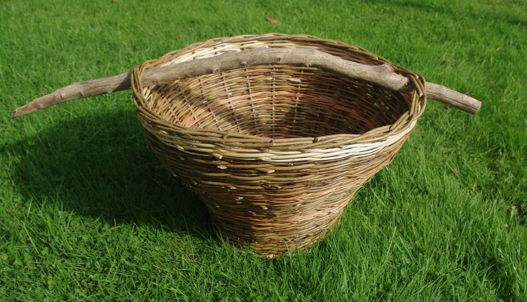 Wood handle on traditional bordered basket basket