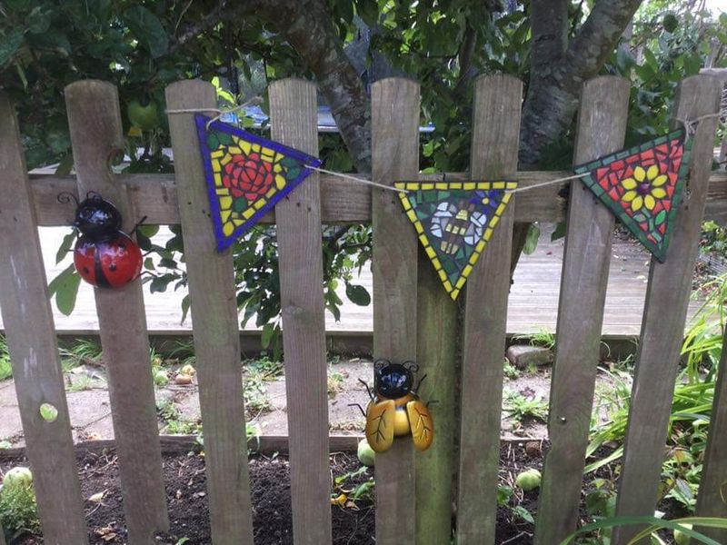 Students mosaic bunting in pride of place in her garden