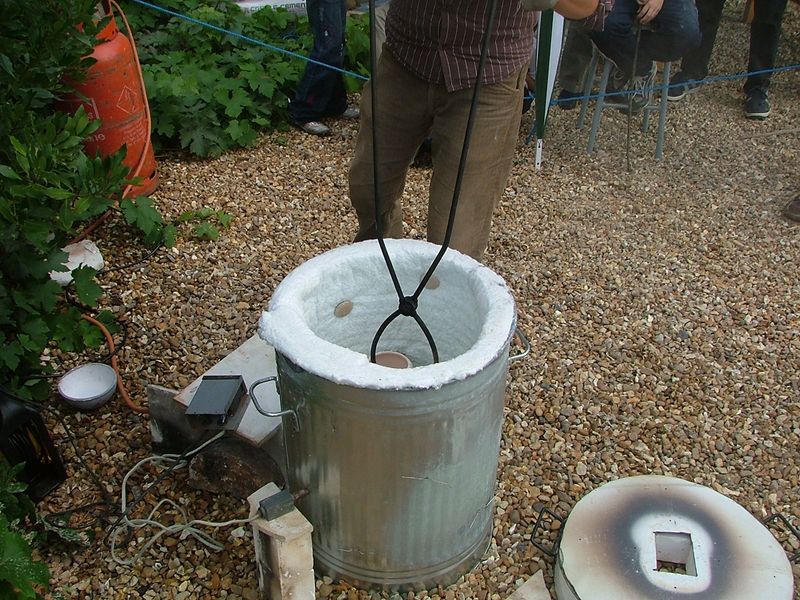 retrieving a pot from the kiln
