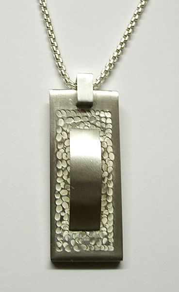 Silver punch textured pendant by Kate Simmonds