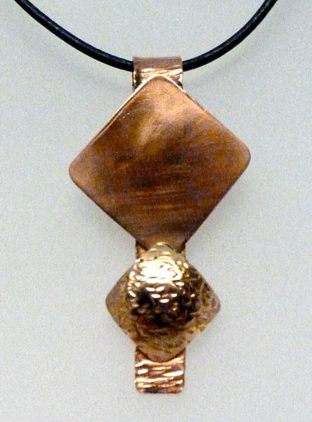 Copper and gilding metal pendant by Carol Sheane