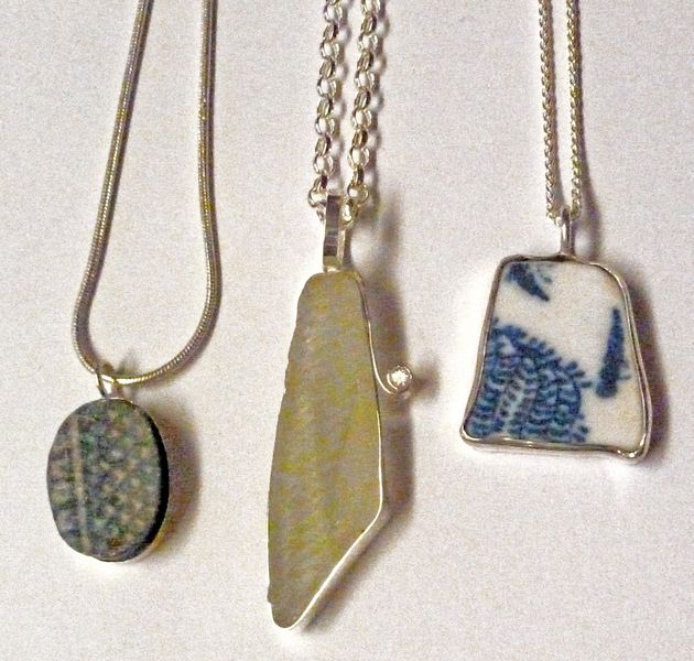 Silver mounted ceramic and glass pendants by Adie Griffin