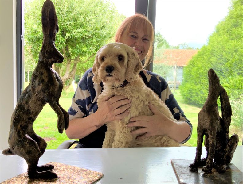 Jo with cockerpoo Tula (who is having a stand-off with a hare!)