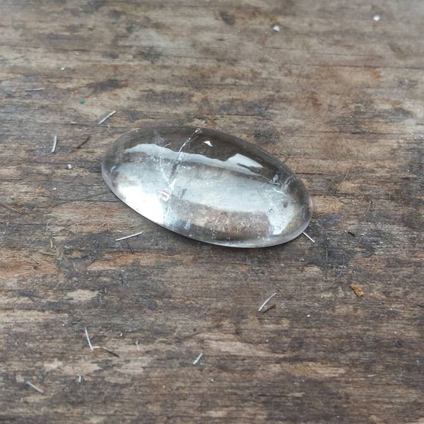 The finished large clear quartz cabochon. This measures 21mm by 11mm.