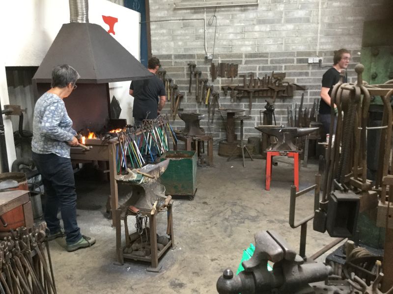 Students at work on a Red Anvil School of Blacksmithing course in Devon