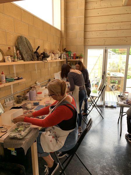 Students in the light and airy studio that is fully heated in the winter.