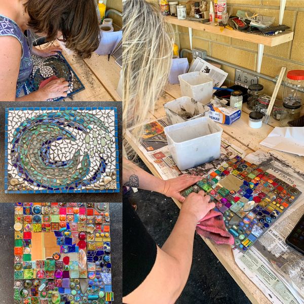 Students at work and the finished mosaic pieces in the left corner.