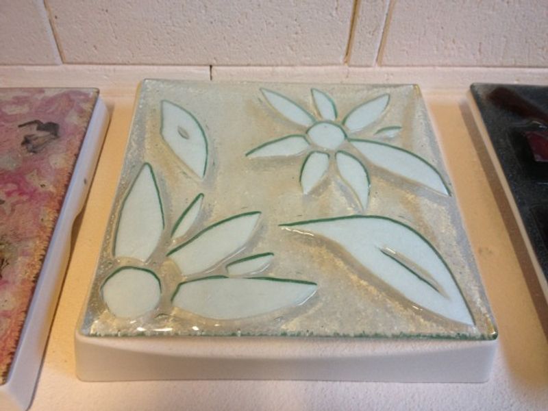 Students using fibre paper to create texture in a bowl during one of our fused glass workshops in Lytham St Annes