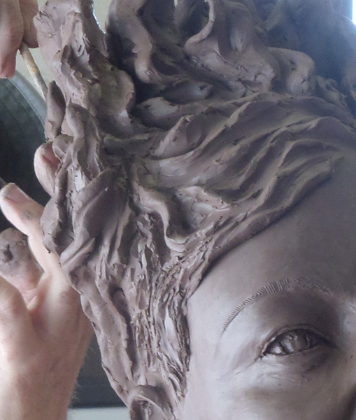 sculpting a clay portrait