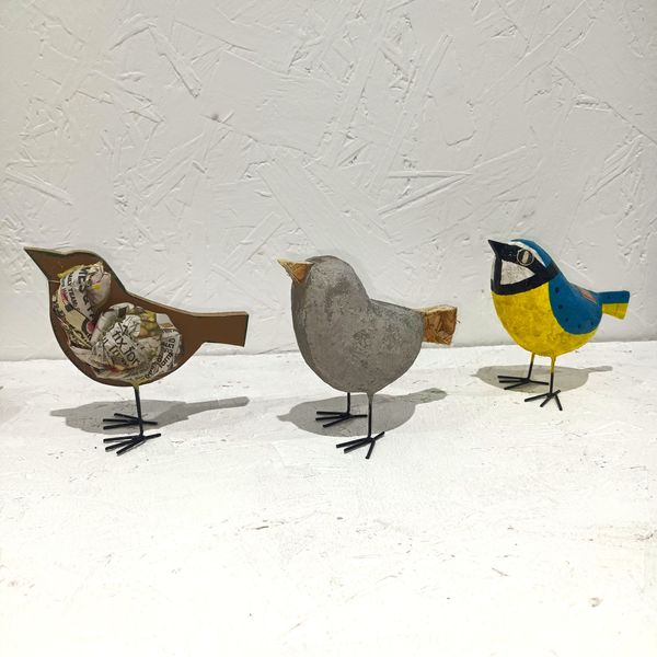 Different stages of a bird sculpture.