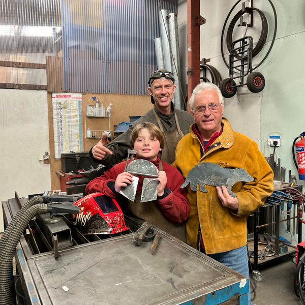 Chris and Theo chuffed with their steel sculptures, and a proud teacher!