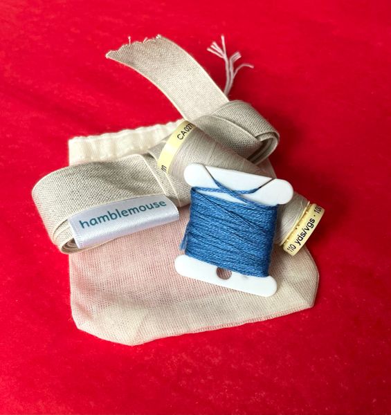 Kit contents: sewing thread, embroidery thread and linen tape for the waist ties