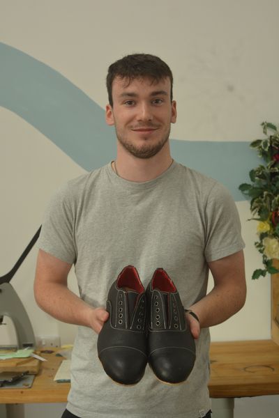 A student with their finished shoes