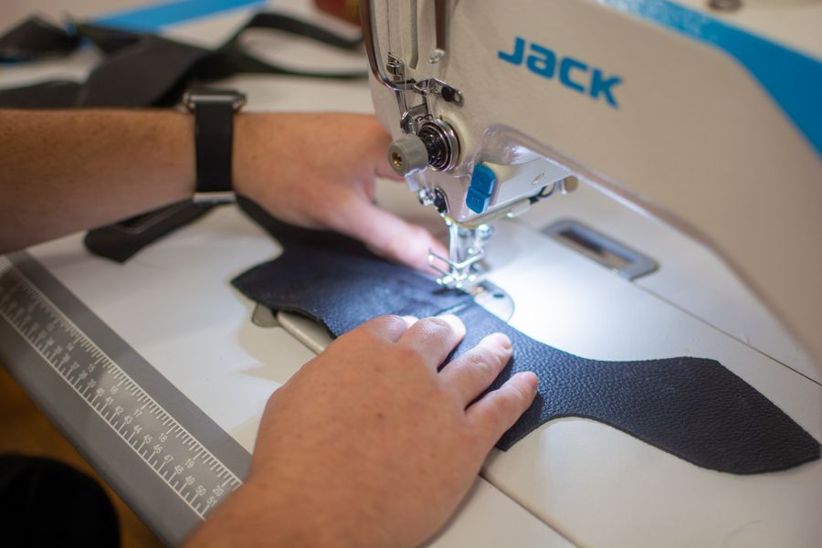 Sewing shoes uppers at the sewing machine.