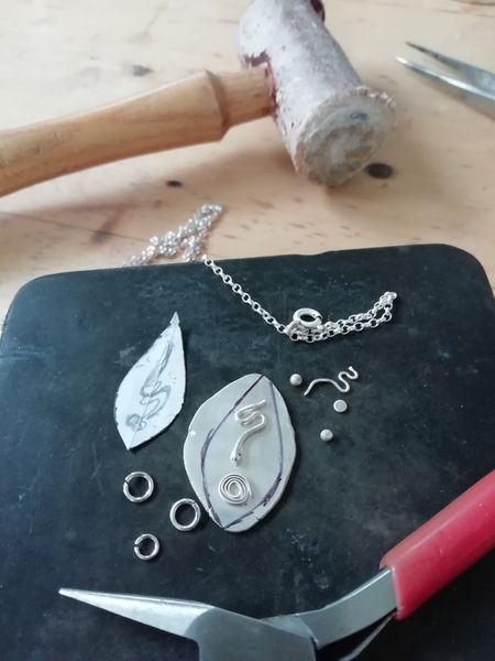 A silver necklace under construction!