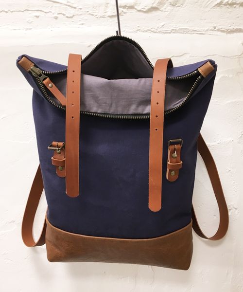 Navy canvas and tan leather rucksack open