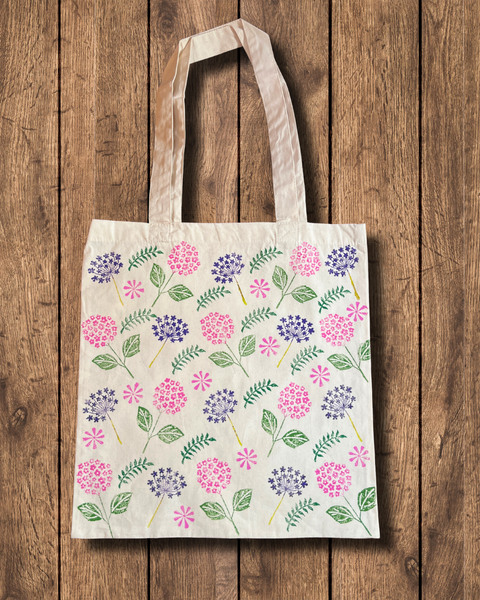 Hand block printed tote bag with flowers and leaves in pink, purple and green