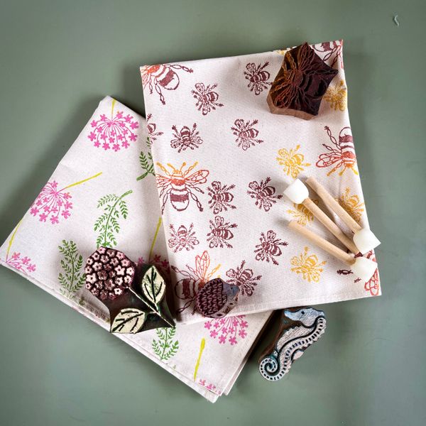 Hand block printed tea towels, wooden printing blocks, and paint sponges