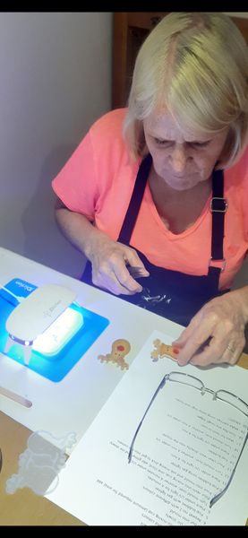 Working in the studio with a UV light making resin earrings.