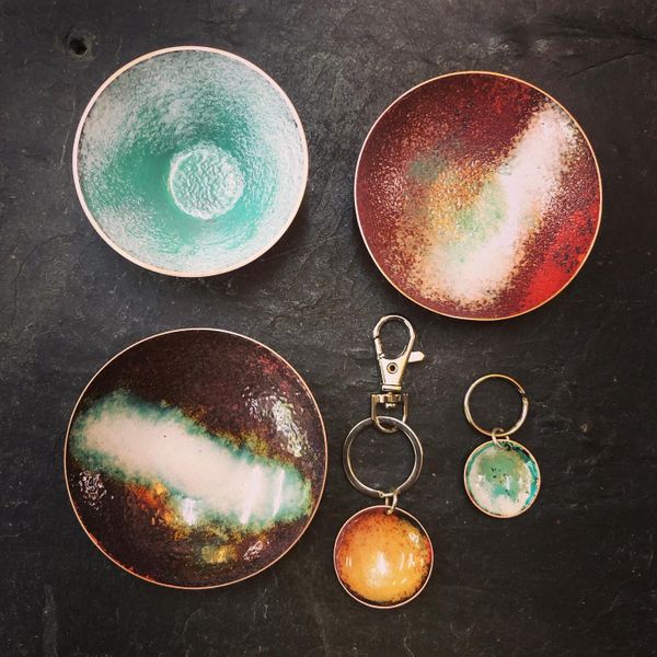 Collection of enamelled bowls and concave pendants made on our day course at Rainbow Glass Studios