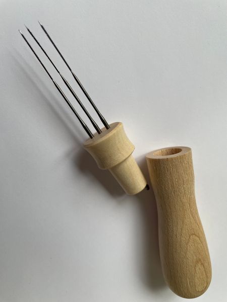 Hand turned Beechwood Needle Tool holds 1, 2, or 3 needles. It has a hollow handle that doubles as a needle holder to keep needle protected while travelling or safely stashed away when little people are visiting. Made in UK