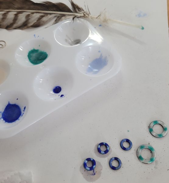 Enamel being applied to copper hoops for earrings
