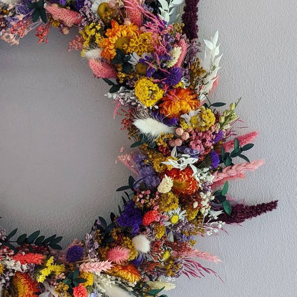 close up of purple orange and yellow dried flower wreath