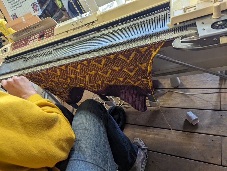 Student with knitting on machine